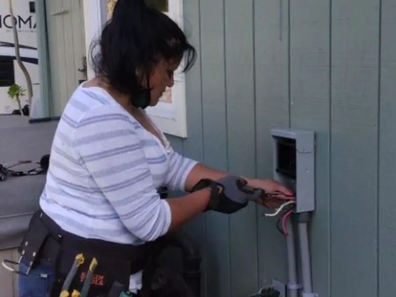 Licensed electrician wiring an exterior subpanel in Highland Park